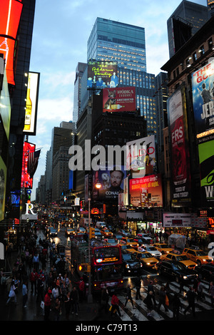 Twilight view, north from TKTS steps, of people traffic neon skyscrapers theatre-land adverts, 7th Avenue, New York City, USA Stock Photo