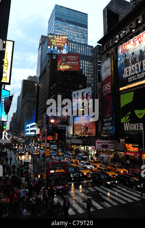 Twilight portrait, north from TKTS steps, of people, traffic, neon skyscrapers, 47th Street junction, 7th Avenue, New York City Stock Photo