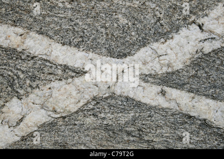 crossing white quartz veins in an x shape Stock Photo