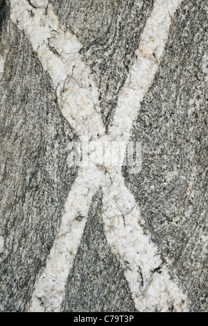 vertical image of crossing rock veins in an x shape Stock Photo