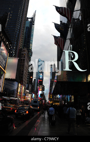 Twilight portrait wet tarmac traffic skyscrapers sidewalk pedestrians Times Square Renaissance Hotel, 7th Avenue, New York City Stock Photo