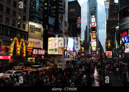 Wet tarmac evening twilight view, from TKTS steps, people traffic neon skyscrapers, 7th Avenue, Times Square, New York City, USA Stock Photo