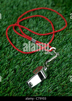 A sports umpires whistle isoltaed on grass Stock Photo