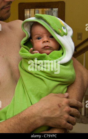 Father Holding Two Month Old Baby Boy Wrapped in Towel after the Baby's Bath Stock Photo