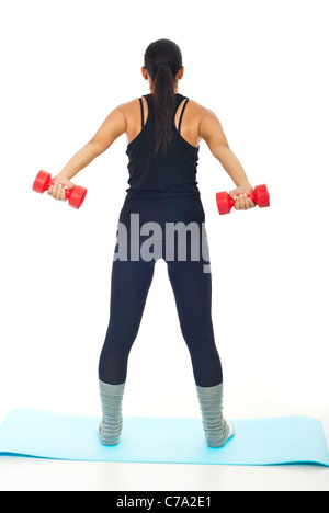 Rear view of women lifting barbell against white background Stock Photo