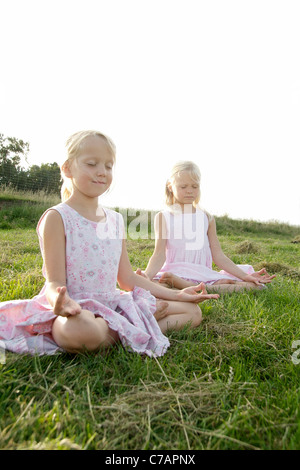 Portrait of two girl friends practicing yoga in summer, Eyendorf, Lower Saxony, Germany, Europe Stock Photo