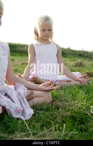 Portrait of two girl friends practicing yoga in summer, Eyendorf, Lower Saxony, Germany, Europe Stock Photo