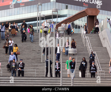 Security staff in police-type uniforms on the steps to the Westfield Shopping Centre, Stratford, London Stock Photo