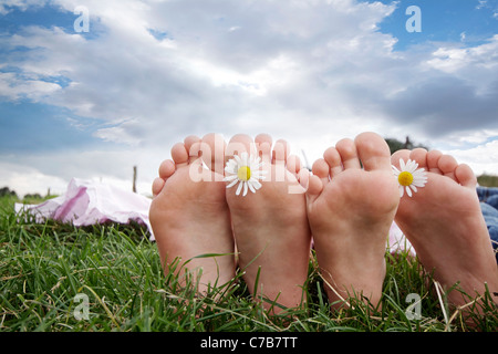 Children playing and relaxing on a meadow in summer, barefoot, Eyendorf, Lower Saxony, Germany, Europe Stock Photo