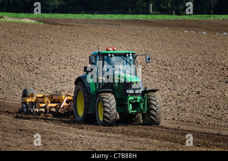 Tractor cultivating a field Stock Photo