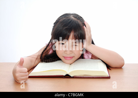 Happy little asian girl reading book , back to school concept, isolated over white Stock Photo