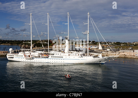 Wind Spirit, a four-masted schooner of the Windstar Cruise Line, entering Roscoff Harbour, France Stock Photo