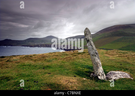 ogham stone on top of slea head on a stormy day rugged atlantic coast coastline Dingle peninsula County Kerry Ireland Stock Photo