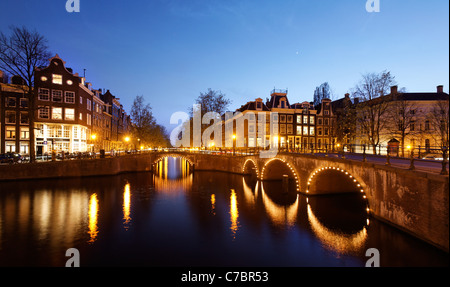 Illuminated canal bridges at night, Amsterdam, Netherlands