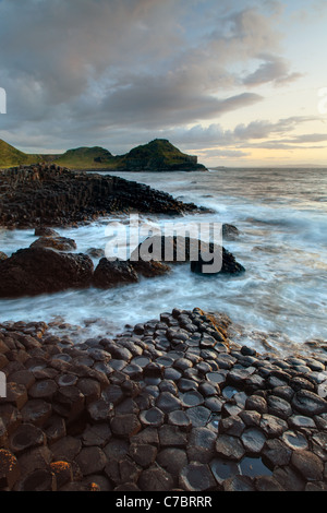 Waves splashing over basalt columns near sunset, Giant's Causeway, County Antrim, Northern Ireland, United Kingdon