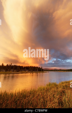 Storm clouds building over Yellowstone River and grassy meadows near sunset, Yellowstone National Park, Wyoming, USA Stock Photo