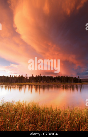 Storm clouds building over Yellowstone River and grassy meadows near sunset, Yellowstone National Park, Wyoming, USA Stock Photo