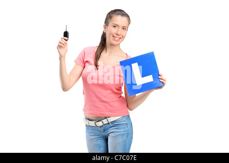 Happy teenager holding a L plate and a car key Stock Photo