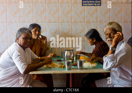 An indian family dining in a simple restaurant in Rameswaram, Tamil Nadu, India. Stock Photo