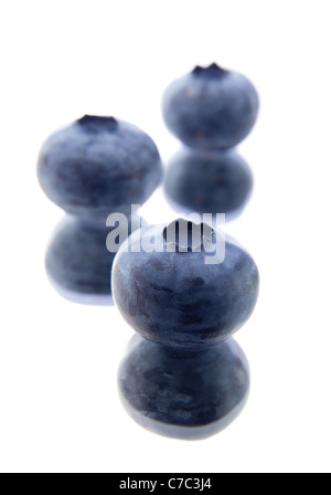 three blueberries on a mirror Stock Photo