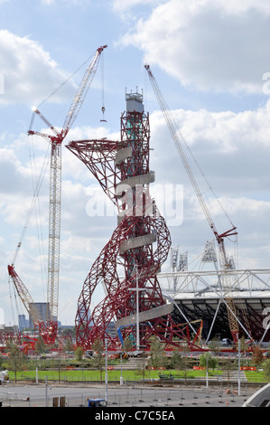 Construction site 2012 Olympics Arcelormittal Orbit tower under construction in the London Olympic park with part of main stadium beyond Stratford UK Stock Photo
