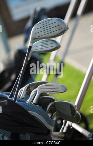 Golf clubs in golfbag, green grass background Stock Photo