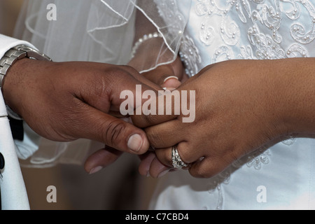 Church African American wedding ceremony couple groom with bride showing off their hands with wedding rings in USA US photography horizontal hi-res Stock Photo