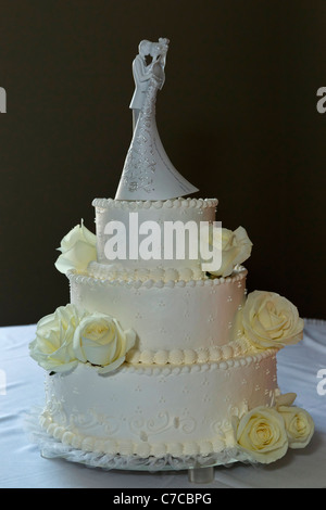 American traditional a wedding white cake decorated with roses and ...