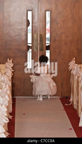 American African wedding ceremony with a little flower girl in the church during a wedding ceremony in USA US lifestyle daily life style  hi-res Stock Photo