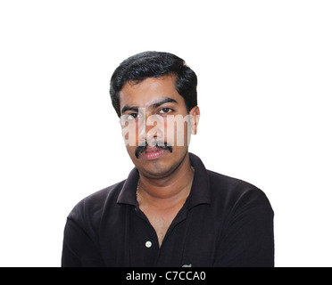 Indian man in black shirt and ripped jeans standing on a rooftop ...