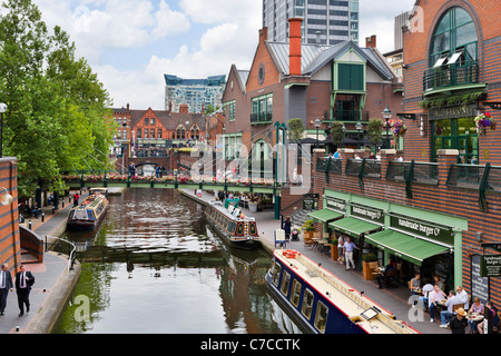 Narrowboats in front of restaurants on the canal at Brindley Place, Birmingham, West Midlands, England, UK Stock Photo