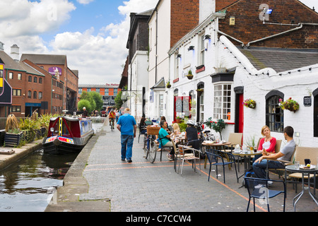 Canalside cafe at Gas Street Basin with Premier Inn and The Mailbox centre in the distance, Birmingham, West Midlands, England Stock Photo