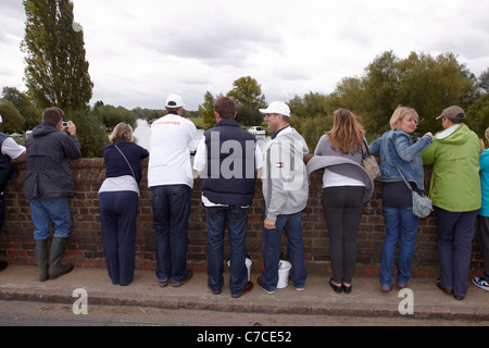 Onlookers gather on a bridge in Clifton Hampden as David Walliams (not pictured) swims past Stock Photo