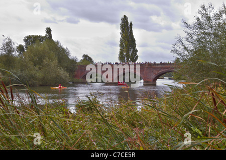 Onlookers gather on a bridge in Clifton Hampden as David Walliams swims past Stock Photo