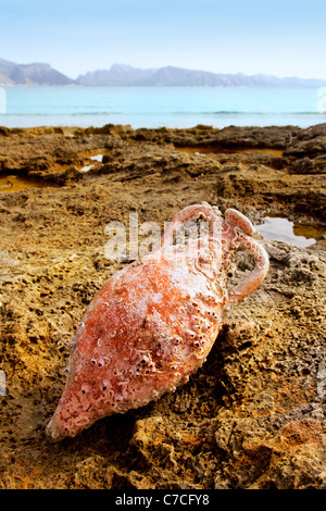 Amphora roman clay pottery with fouling in the beach of Acudia Barcares at Mallorca Stock Photo