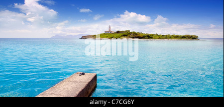 Aucanada Alcanada beach with pier view to island and lighthouse in Mallorca Balearics Stock Photo