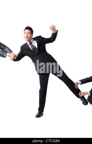 Portrait of a Businessman Pulled in All Directions Stock Photo - Alamy