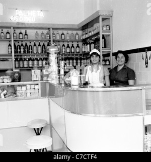 Young waitress and woman behind counter of bar Rio de Janeiro. Historical picture from Brazil taken 1950s by J. Allan Cash. Stock Photo