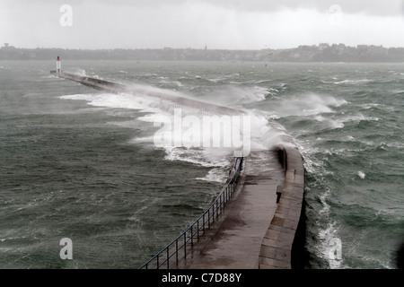 Storm in St Malo, powerful waves against the pier (Le Môle des Noires),  Brittany, France. Stock Photo