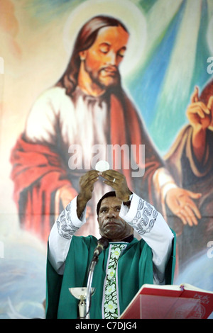 Roman catholic priest consecrating the host, Papua New Guinea Stock Photo