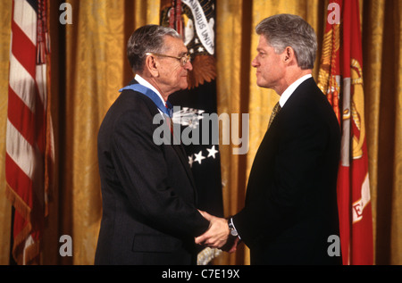 U.S. President Bill Clinton presents retired Marine Major General James L. Day, left, with the Medal of Honor during the presentation ceremony in the East Room of the White House, January 20, 1998 in Washington, D.C. Day was awarded the Medal of Honor for his heroic actions during the Battle of Okinawa in World War II. Stock Photo