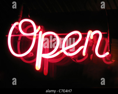 A neon 'open' sign glowing red in the window of a restaurant. Stock Photo