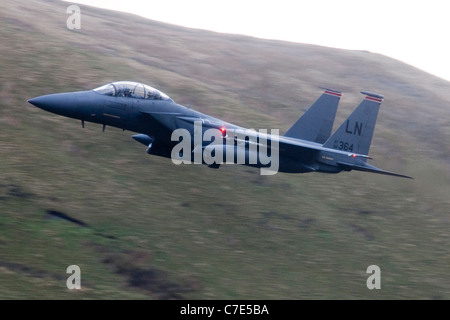 USAF F-15E Strike Eagle makes a turn mountains of Snowdonia in the background during a low flying flight