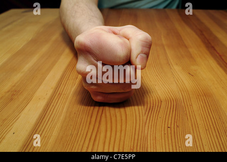 Man banging his fist on a table Stock Photo