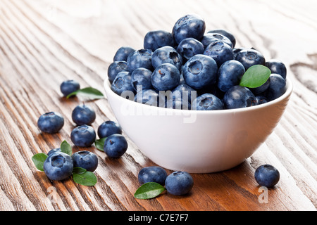 Blueberries in a bowl on a wooden table. Stock Photo