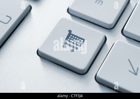 Shopping cart icon on keyboard key. Toned Image. Stock Photo