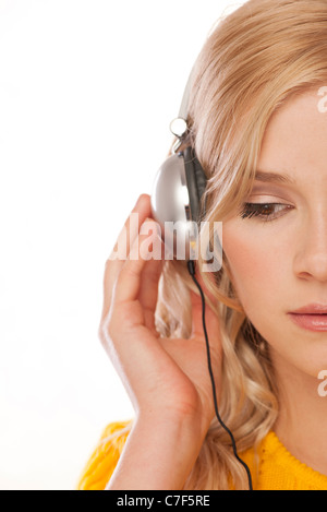 Blonde caucasian woman listening to music using headphones smiling with ...