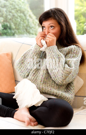 Girl with cold blowing nose Stock Photo