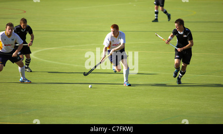 Male hockey players in action on an astro turf pitch Stock Photo