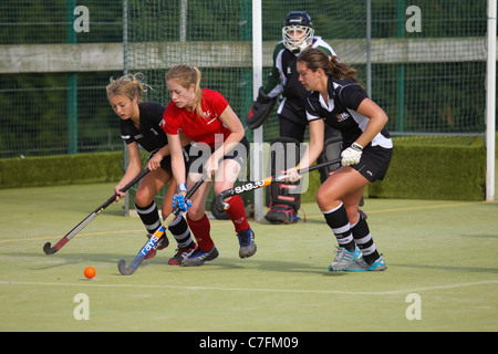 Female hockey players in action on an astro turf pitch Stock Photo